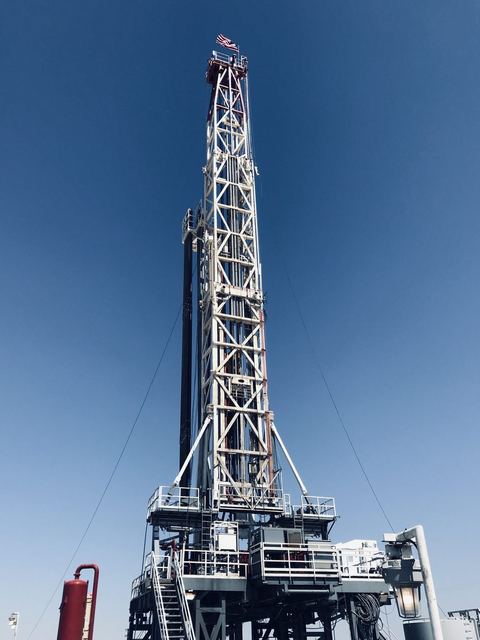Land drilling rig derrick against a clear sky