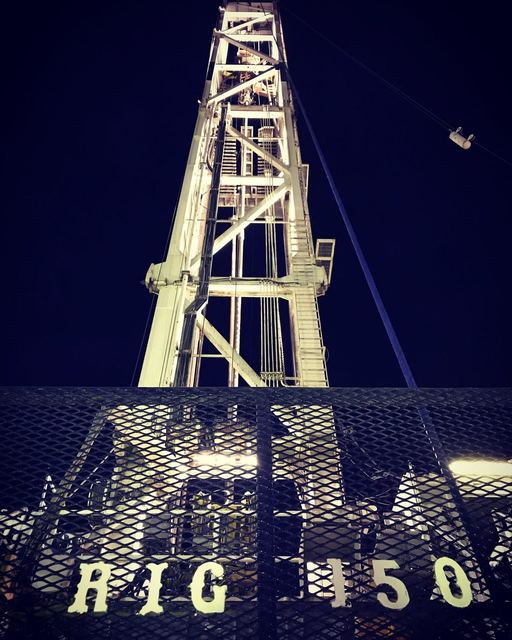 Lit derrick of Rig 150 at night